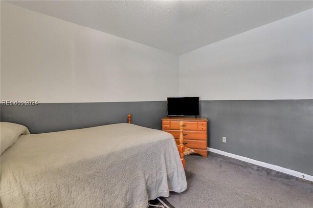 carpeted bedroom featuring a textured ceiling