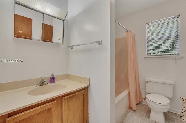 full bathroom featuring vanity, shower / bath combination with curtain, and toilet