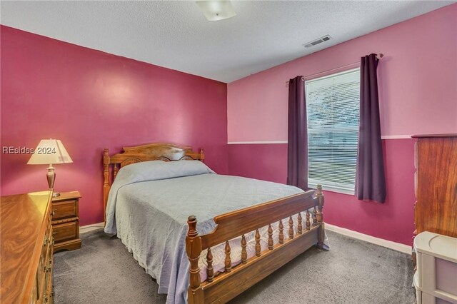 carpeted bedroom with a textured ceiling