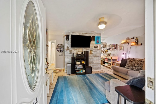 tiled living room with ceiling fan