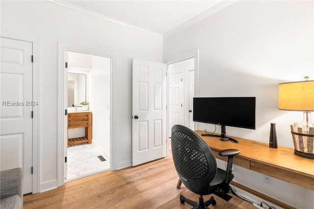 home office with ornamental molding and light hardwood / wood-style floors