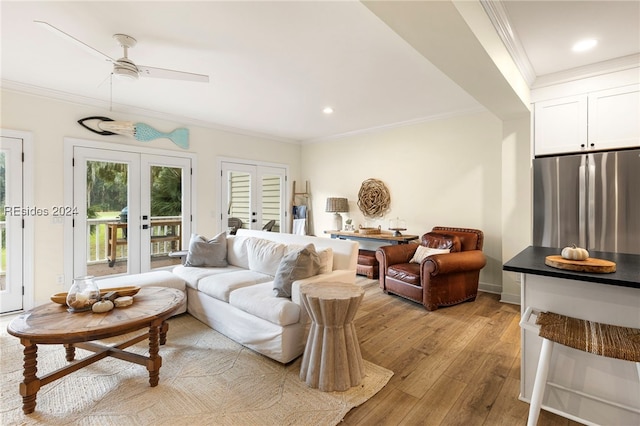 living room featuring french doors, ornamental molding, and light hardwood / wood-style flooring