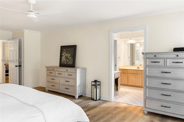 bedroom with sink, ornamental molding, ceiling fan, ensuite bath, and light hardwood / wood-style flooring