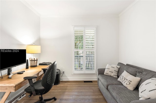 office with hardwood / wood-style floors and crown molding