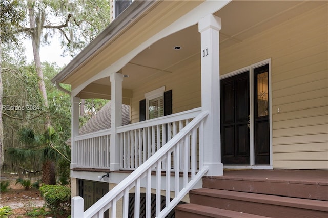 view of exterior entry with a porch