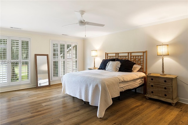 bedroom with multiple windows, ornamental molding, dark wood-type flooring, and ceiling fan