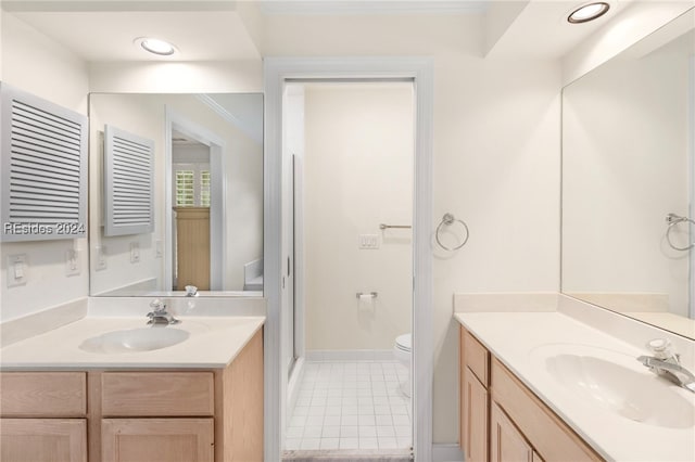 bathroom with vanity, toilet, and a shower with door