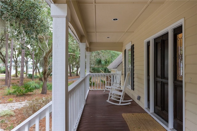 wooden terrace featuring covered porch