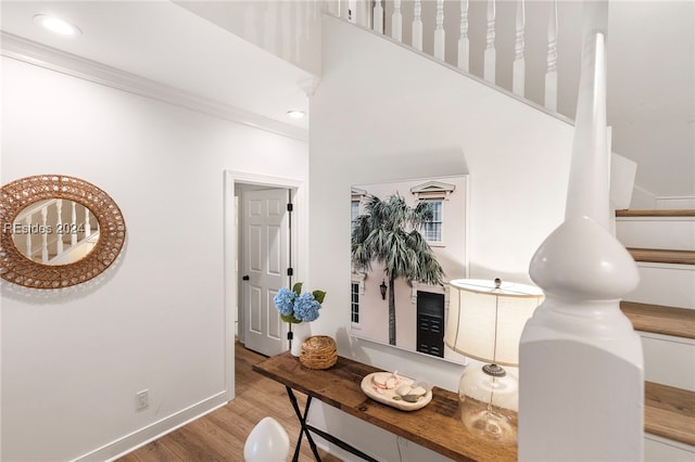 interior space with crown molding and light wood-type flooring