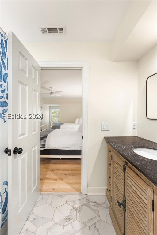 bathroom featuring ceiling fan and vanity