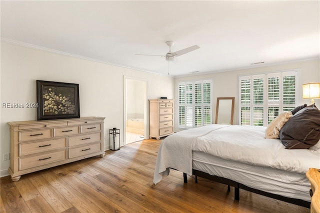 bedroom with crown molding, light hardwood / wood-style floors, ceiling fan, and ensuite bathroom