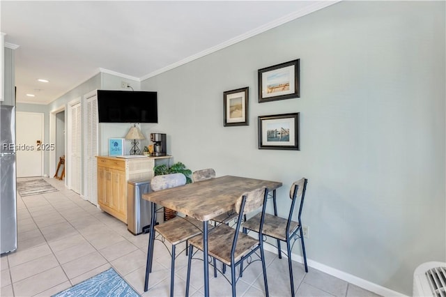 tiled dining area featuring ornamental molding