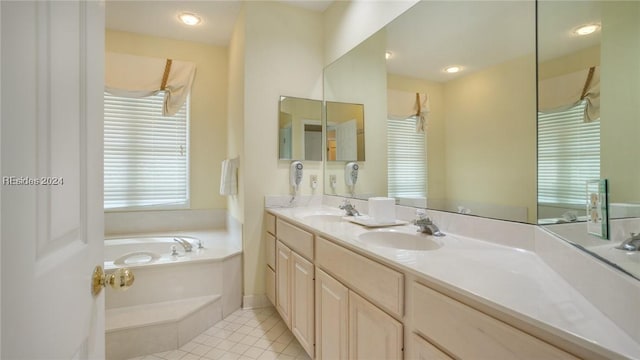 bathroom featuring vanity, tile patterned floors, and a tub