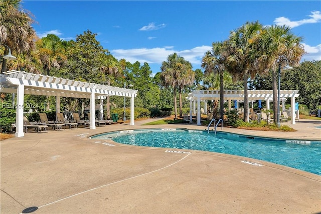 view of swimming pool featuring a patio and a pergola