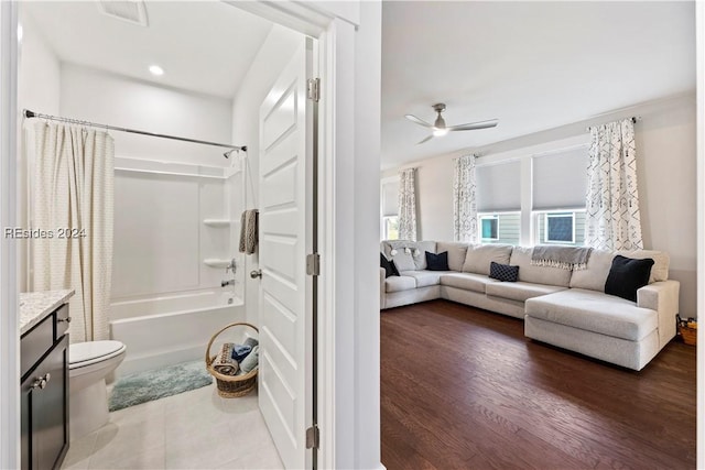 full bathroom featuring toilet, vanity, shower / bath combo, ceiling fan, and hardwood / wood-style floors