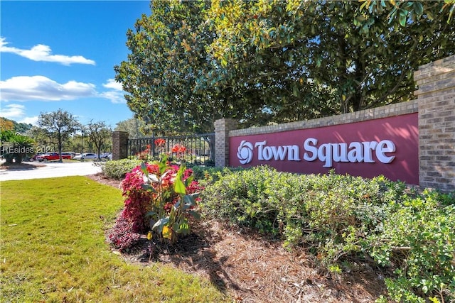 community sign featuring a lawn