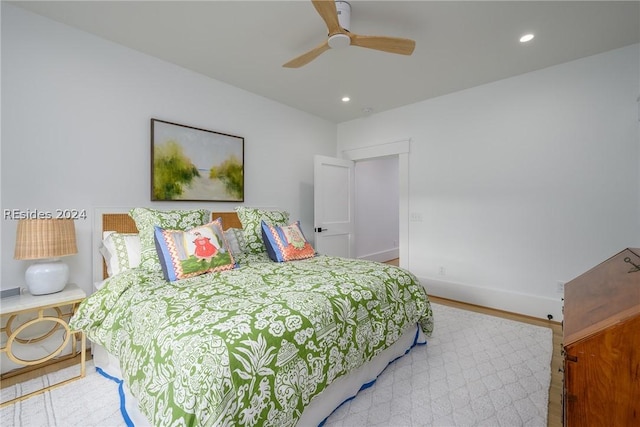 bedroom with wood-type flooring and ceiling fan