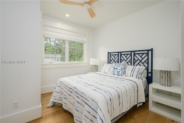 bedroom with hardwood / wood-style floors and ceiling fan