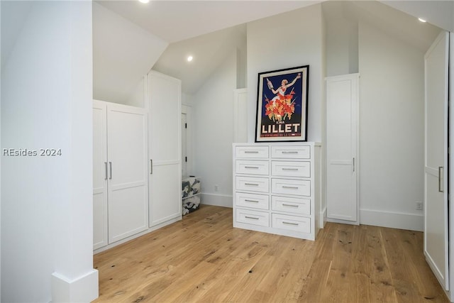 interior space with vaulted ceiling and light hardwood / wood-style flooring