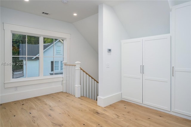 bonus room featuring vaulted ceiling and light hardwood / wood-style floors