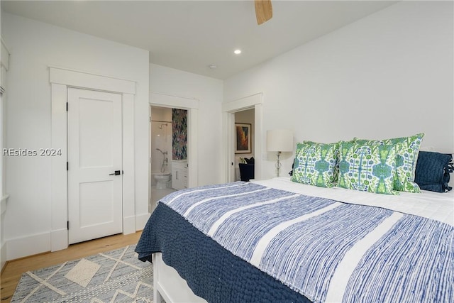 bedroom with wood-type flooring, ceiling fan, and ensuite bathroom