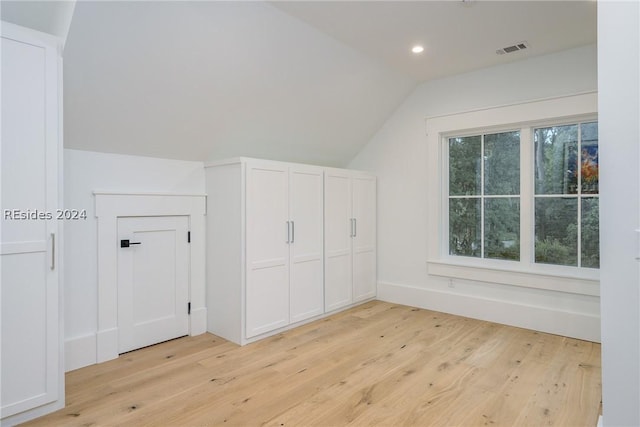 bonus room featuring lofted ceiling and light hardwood / wood-style floors