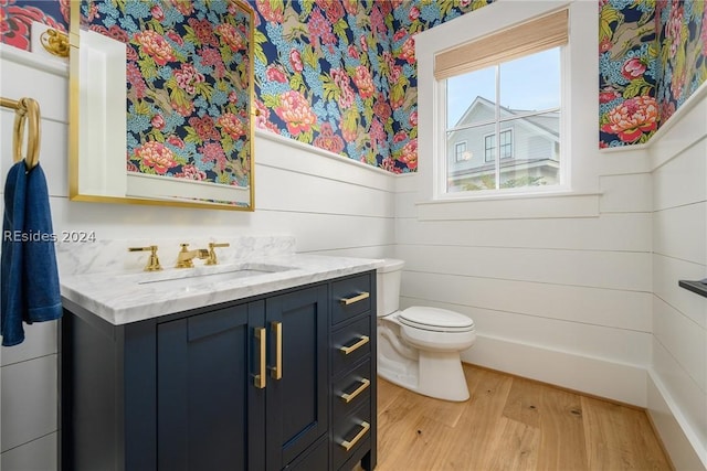 bathroom featuring hardwood / wood-style flooring, vanity, and toilet