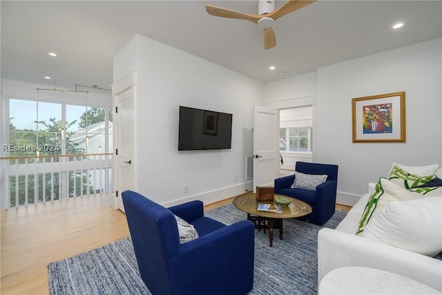 living room featuring hardwood / wood-style floors and ceiling fan