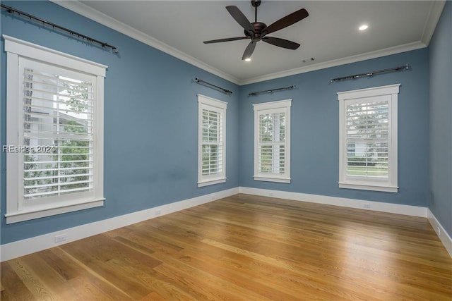 empty room with hardwood / wood-style flooring, ceiling fan, and ornamental molding