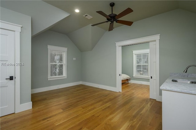 bonus room featuring ceiling fan, lofted ceiling, sink, and light wood-type flooring