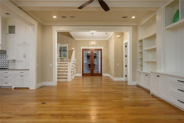 entrance foyer with wood ceiling, light hardwood / wood-style flooring, ornamental molding, and french doors