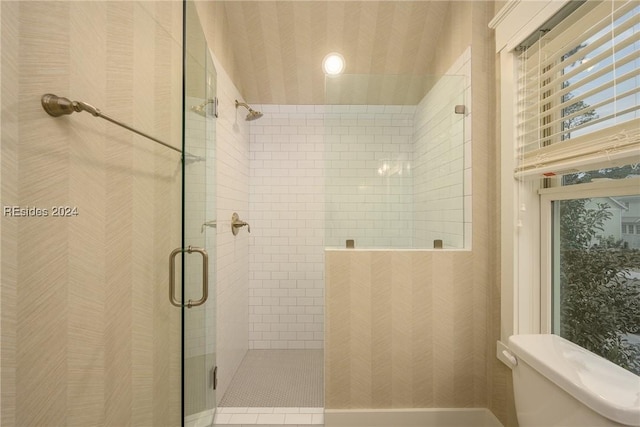 bathroom with toilet and a shower with shower door