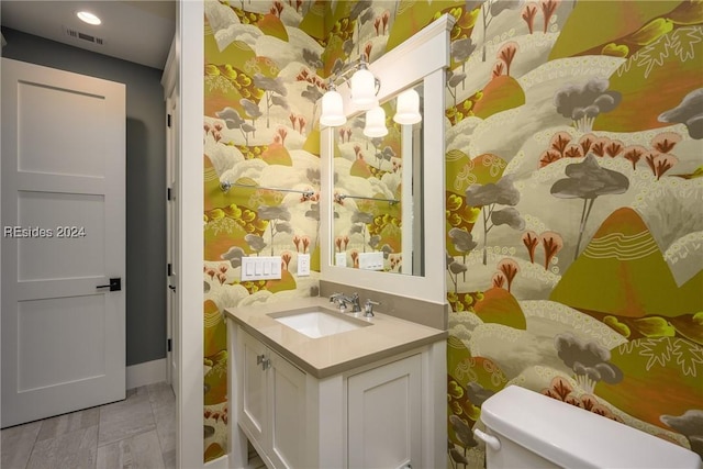 bathroom with vanity, tile patterned floors, and toilet