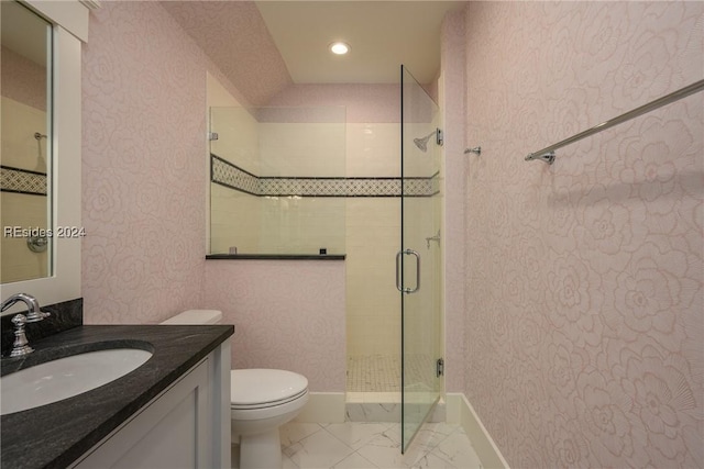 bathroom with vanity, a shower with shower door, and toilet