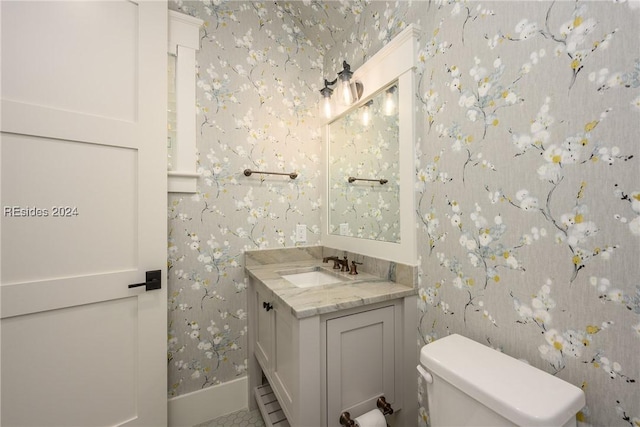 bathroom featuring vanity, tile patterned floors, and toilet