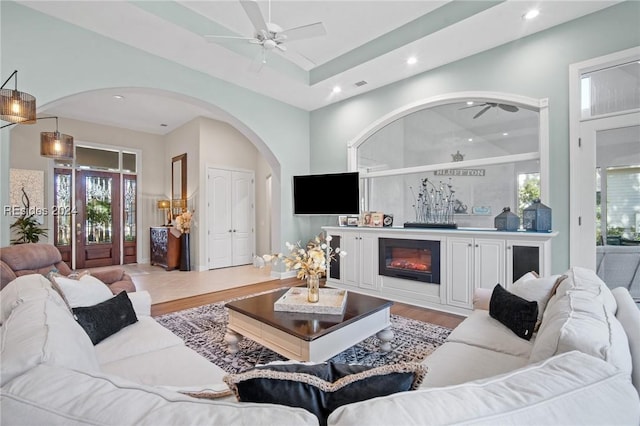 living room featuring ceiling fan and light hardwood / wood-style flooring