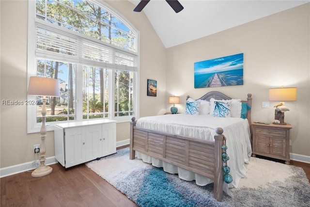 bedroom featuring multiple windows, vaulted ceiling, hardwood / wood-style floors, and ceiling fan