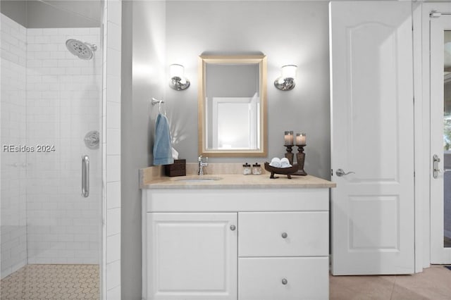 bathroom featuring vanity, tile patterned floors, and a shower with shower door