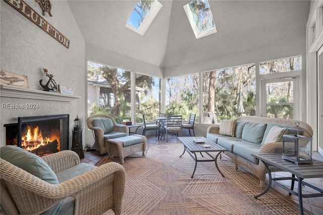 sunroom / solarium with a tile fireplace and vaulted ceiling with skylight