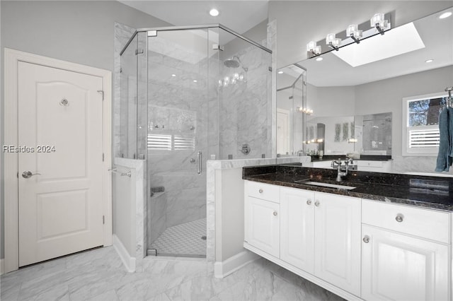 bathroom with walk in shower, vanity, and a skylight