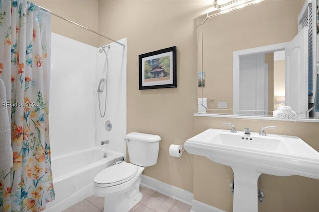 bathroom featuring tile patterned flooring, shower / tub combo, and toilet