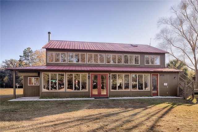 rear view of property with a yard and french doors