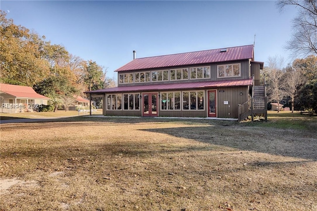 back of house featuring a lawn