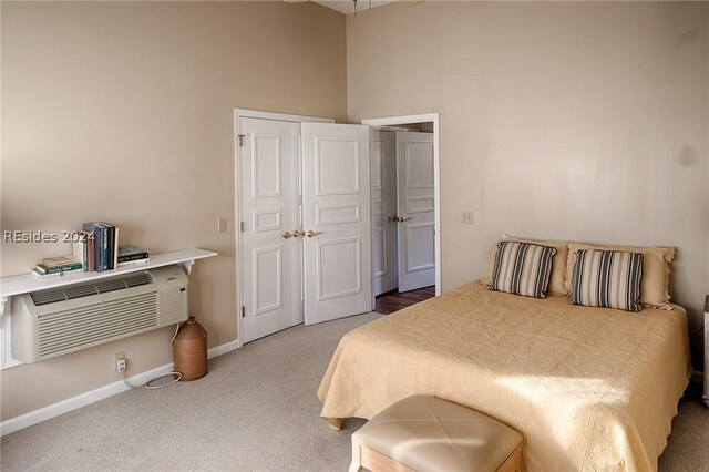 bedroom featuring carpet and an AC wall unit