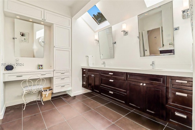 bathroom featuring tile patterned floors, a skylight, and vanity