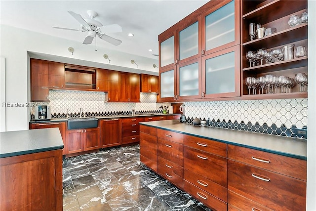 kitchen featuring tasteful backsplash, sink, and ceiling fan