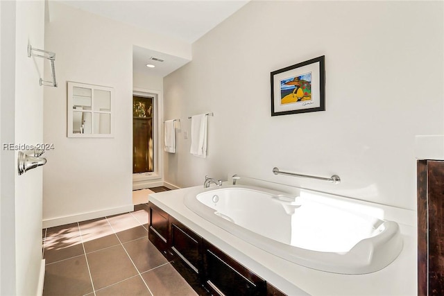 bathroom with tile patterned flooring and a washtub