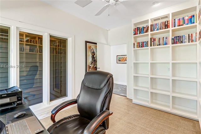 home office with light carpet and ceiling fan