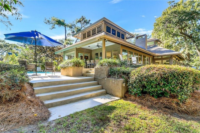 rear view of house featuring a patio and ceiling fan