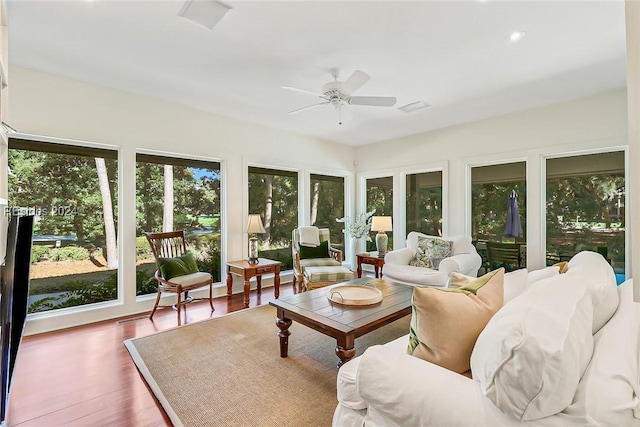 sunroom / solarium featuring ceiling fan